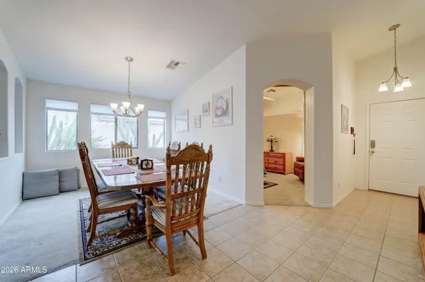 a view of a dining room with furniture and chandelier