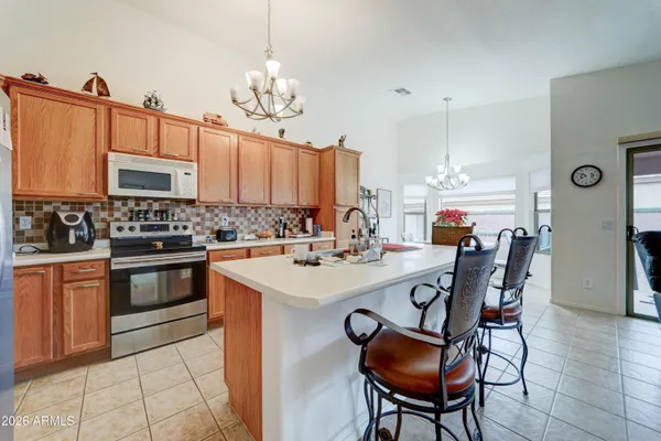 a kitchen with a dining table and chairs