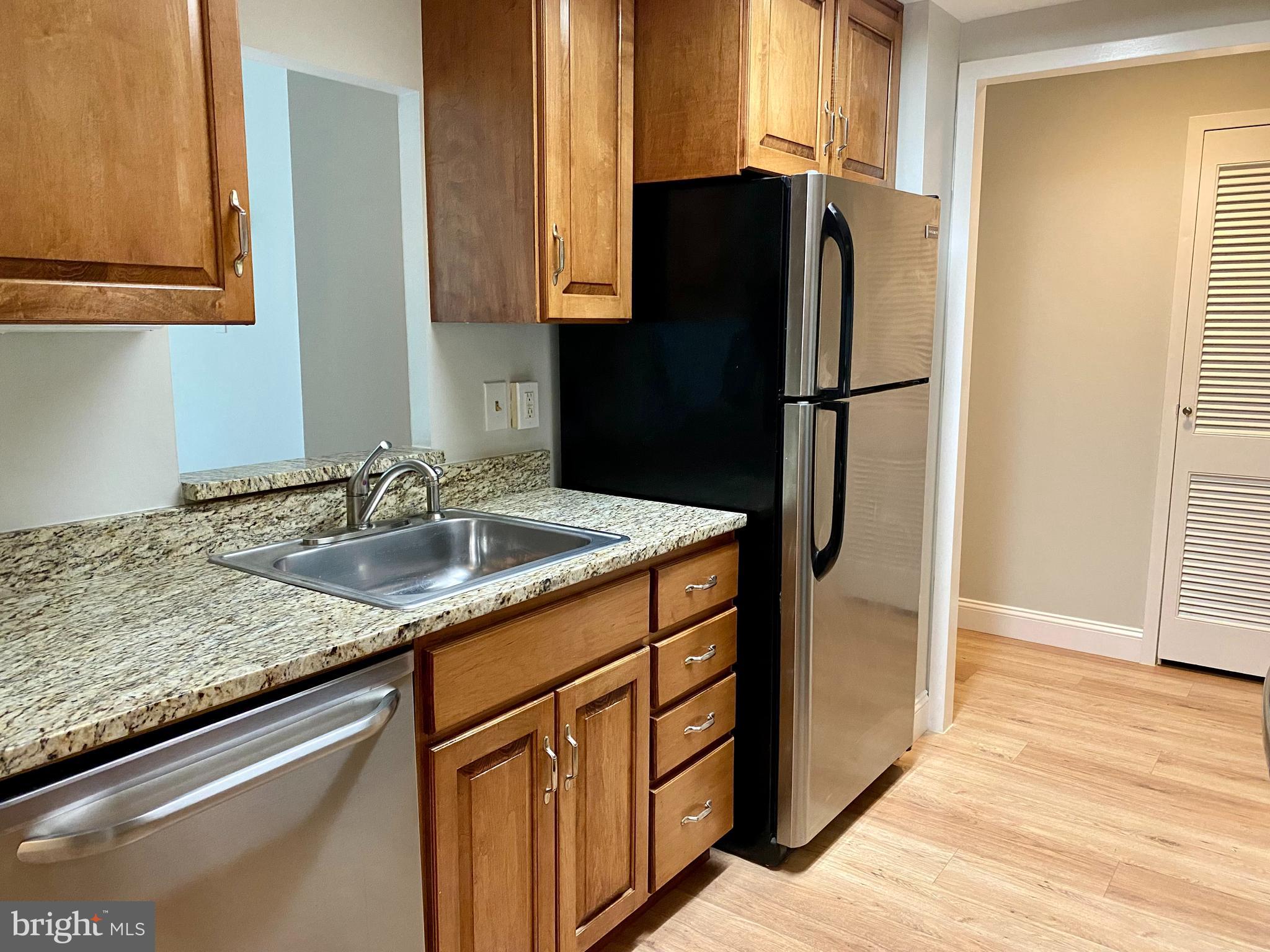 100 West Avenue, Unit 218S Jenkintown, PA 19046 - Photo 15 of 29 a kitchen with stainless steel appliances granite countertop a refrigerator and a sink