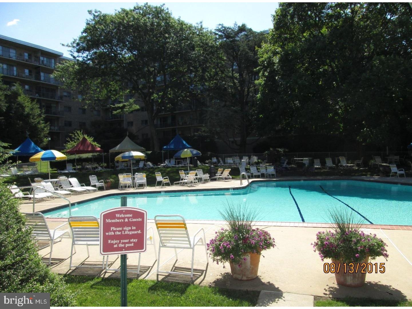 100 West Avenue, Unit 218S Jenkintown, PA 19046 - Photo 28 of 29 a view of swimming pool with outdoor seating and green space
