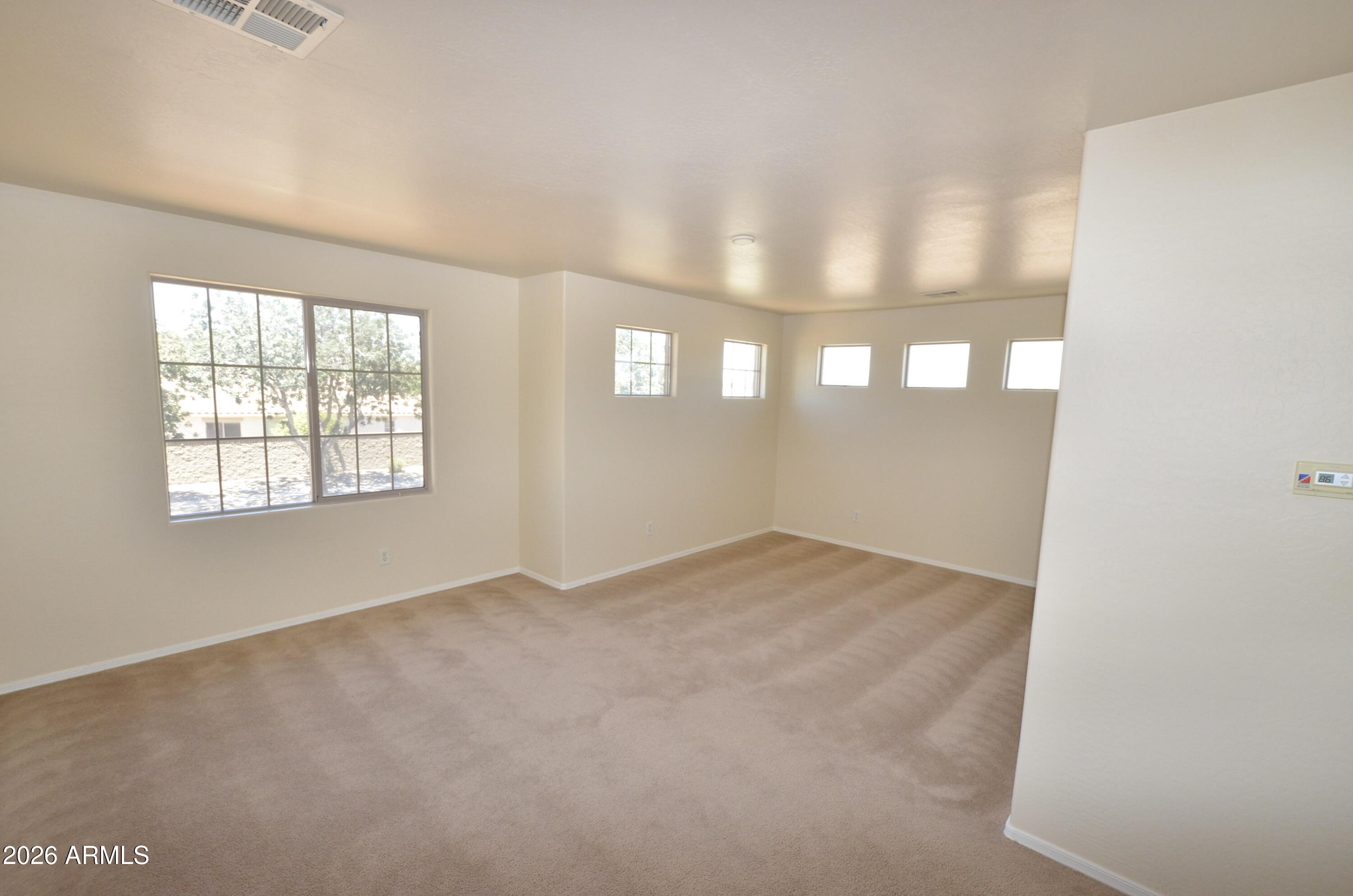 3995 East Trigger Way Gilbert, AZ 85297 - Photo 14 of 23 an empty room with windows and entrance