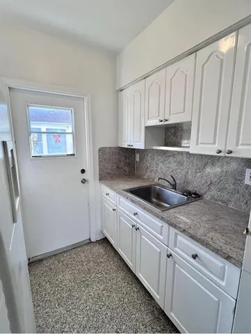 an empty room with a empty space and windows