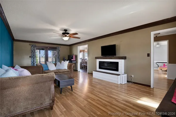 a living room with fireplace furniture and a flat screen tv