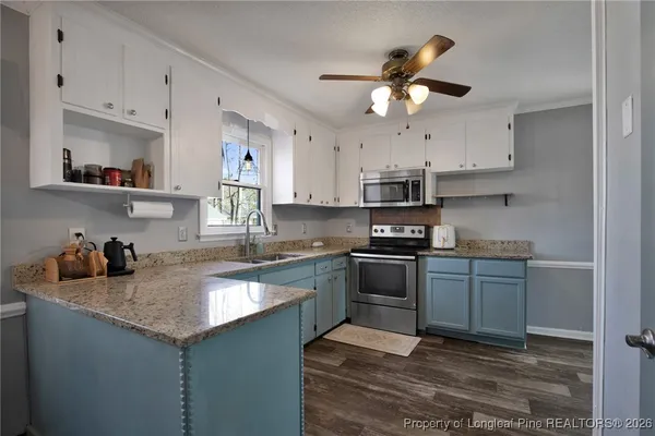 a kitchen with a sink stainless steel appliances and cabinets