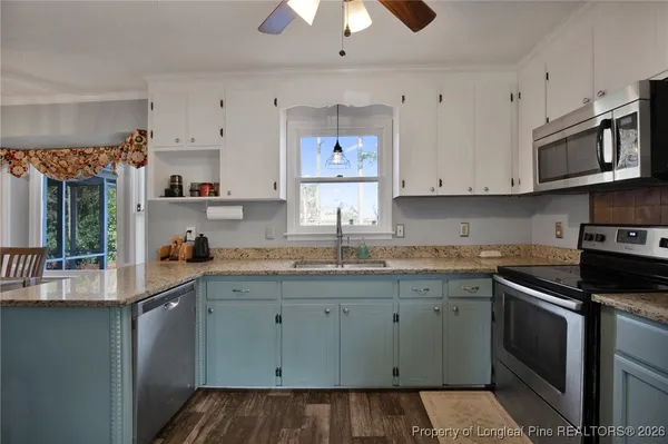 a kitchen with stainless steel appliances granite countertop a sink and cabinets