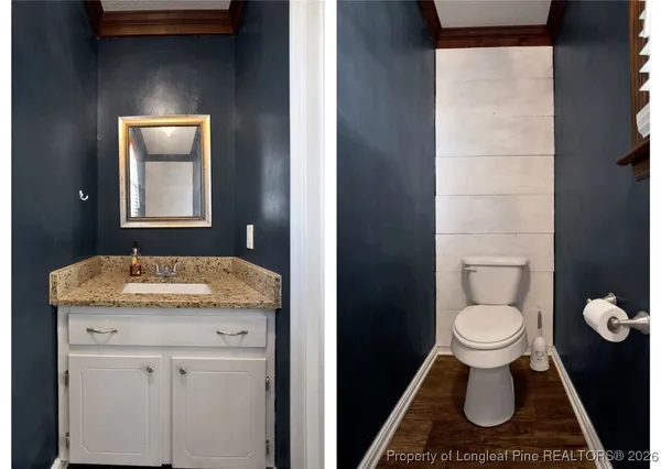 a bathroom with a granite countertop toilet and a sink