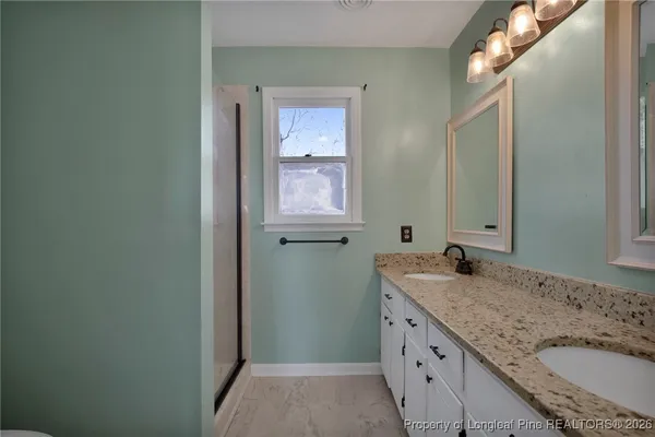 a bathroom with sink granite and mirror