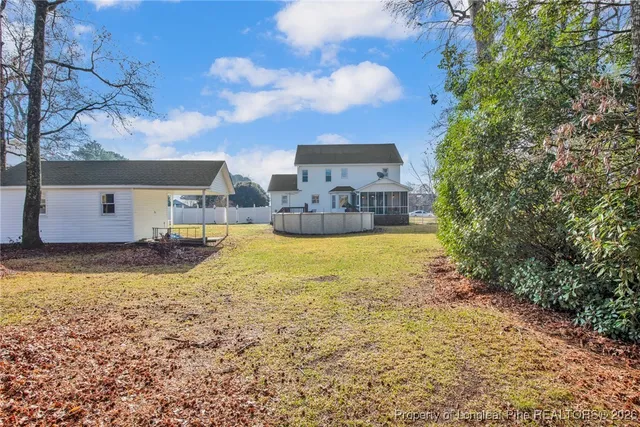 a view of a house with a yard and sitting area