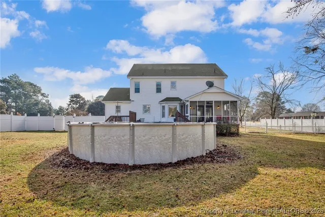a view of a house with a yard covered with snow in front of house