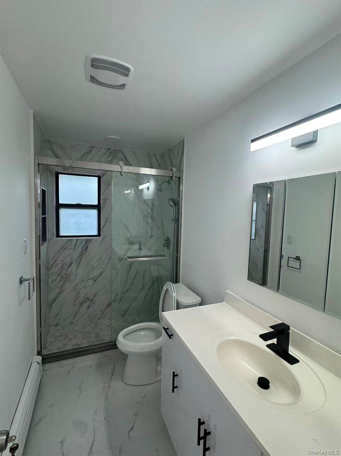 376 Newbridge Road East Meadow, NY 11554 - Photo 7 of 7 a bathroom with a sink toilet and shower