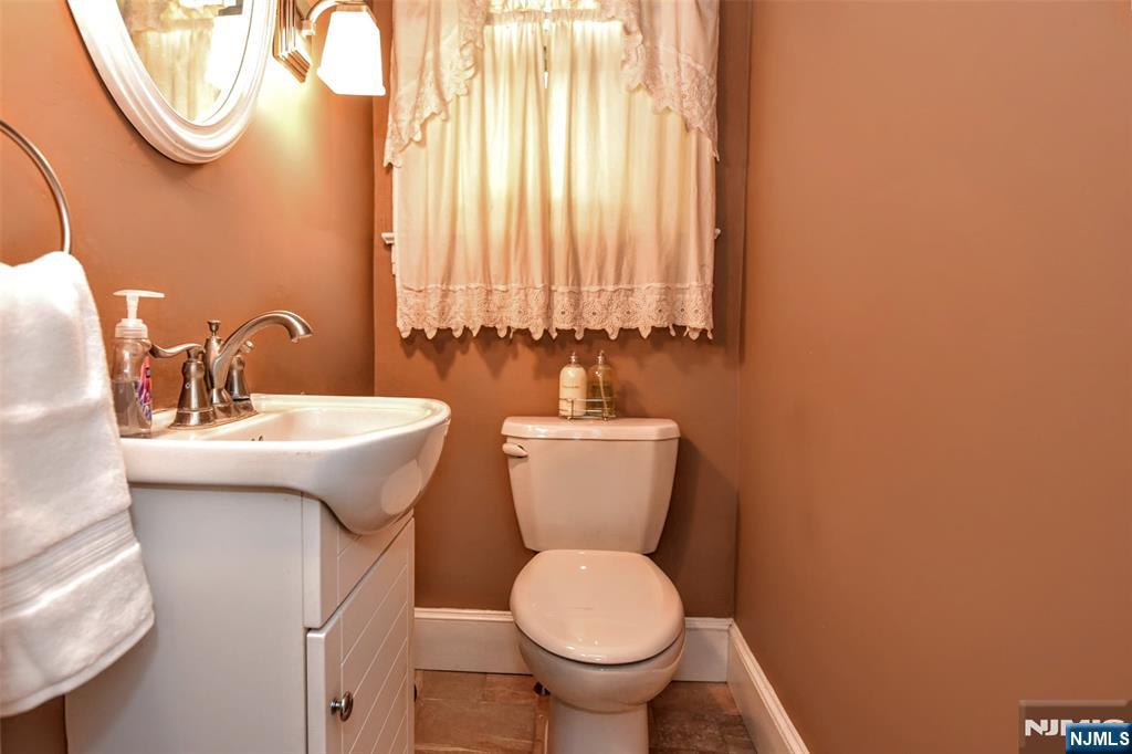 255 Pearsall Avenue Ridgewood, NJ 07450 - Photo 20 of 39 a bathroom with a sink mirror and toilet