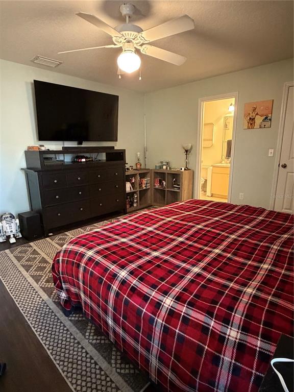 2861 Surf Drive Deltona, FL 32738 - Photo 13 of 20 a bedroom with a bed and a flat screen tv