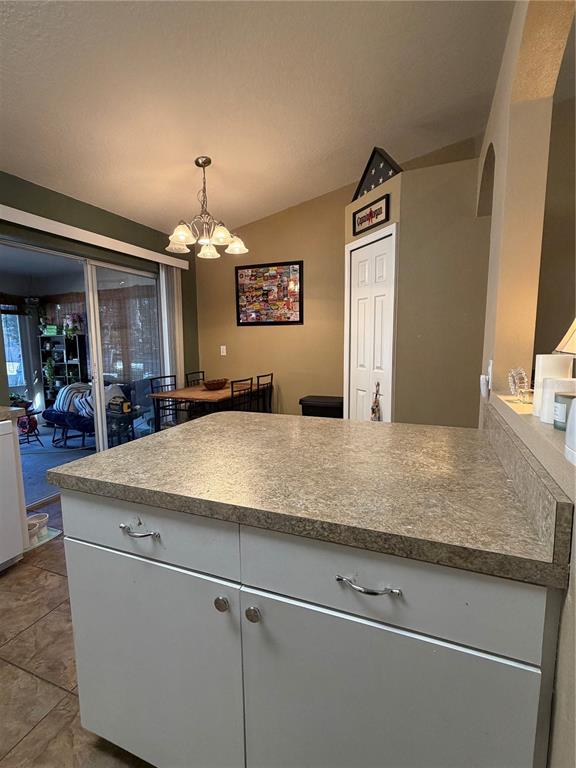 2861 Surf Drive Deltona, FL 32738 - Photo 17 of 20 a view living room with kitchen island stainless steel appliances wooden floor and living room view