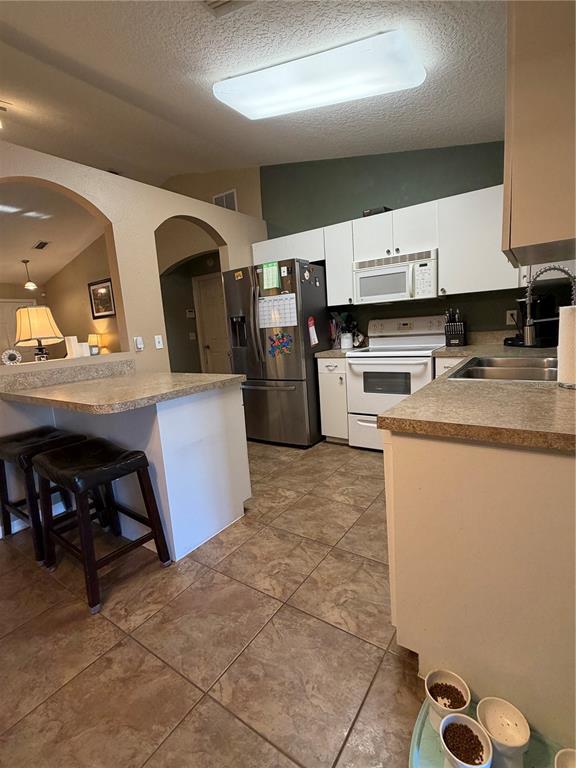 2861 Surf Drive Deltona, FL 32738 - Photo 19 of 20 a kitchen with a sink appliances and cabinets