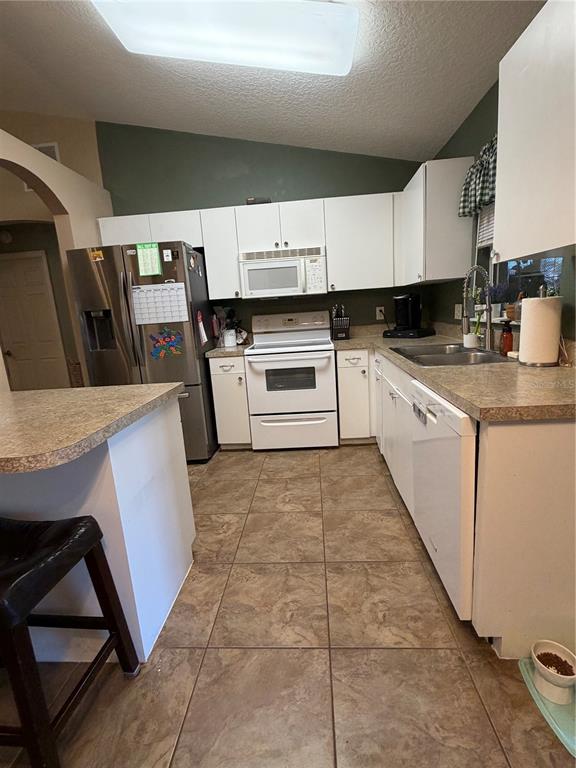 2861 Surf Drive Deltona, FL 32738 - Photo 20 of 20 a kitchen with cabinets and white appliances