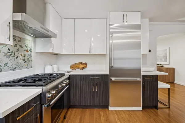 a kitchen with kitchen island stainless steel appliances and wooden cabinets