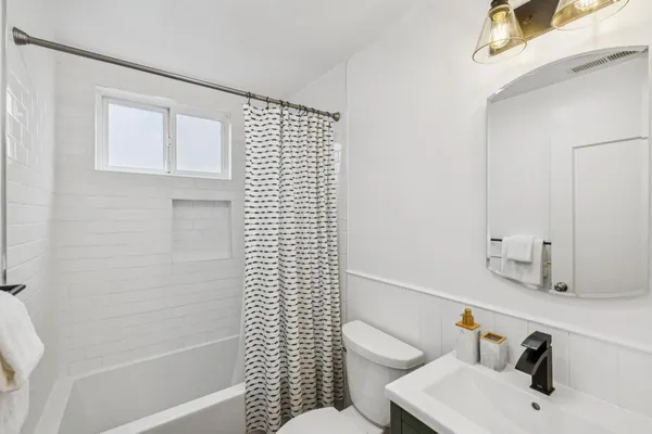 a bathroom with a sink toilet and shower