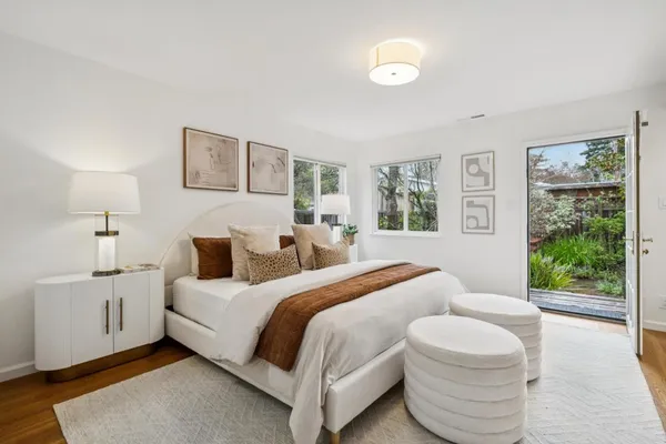 a bedroom with a bed and a large window