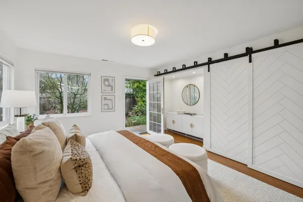 a bedroom with a bed dresser and a window