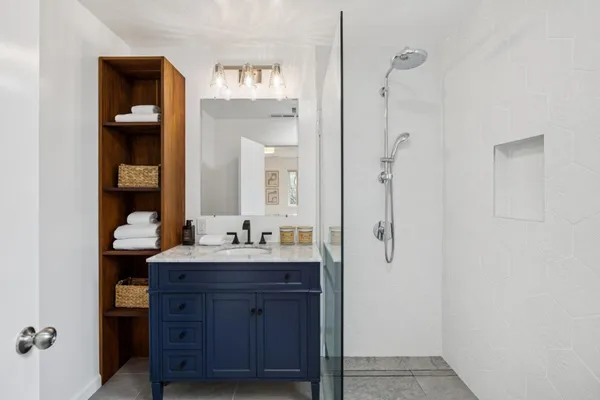 a bathroom with a double vanity sink and mirror