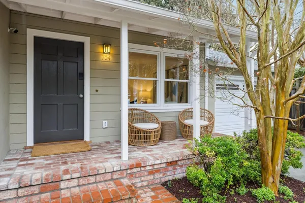 a front view of a house with a garden