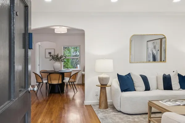 a living room with furniture and wooden floor
