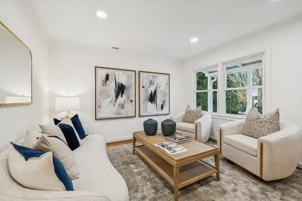 a living room with furniture rug and window