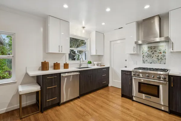 a kitchen with a stove a sink and a refrigerator
