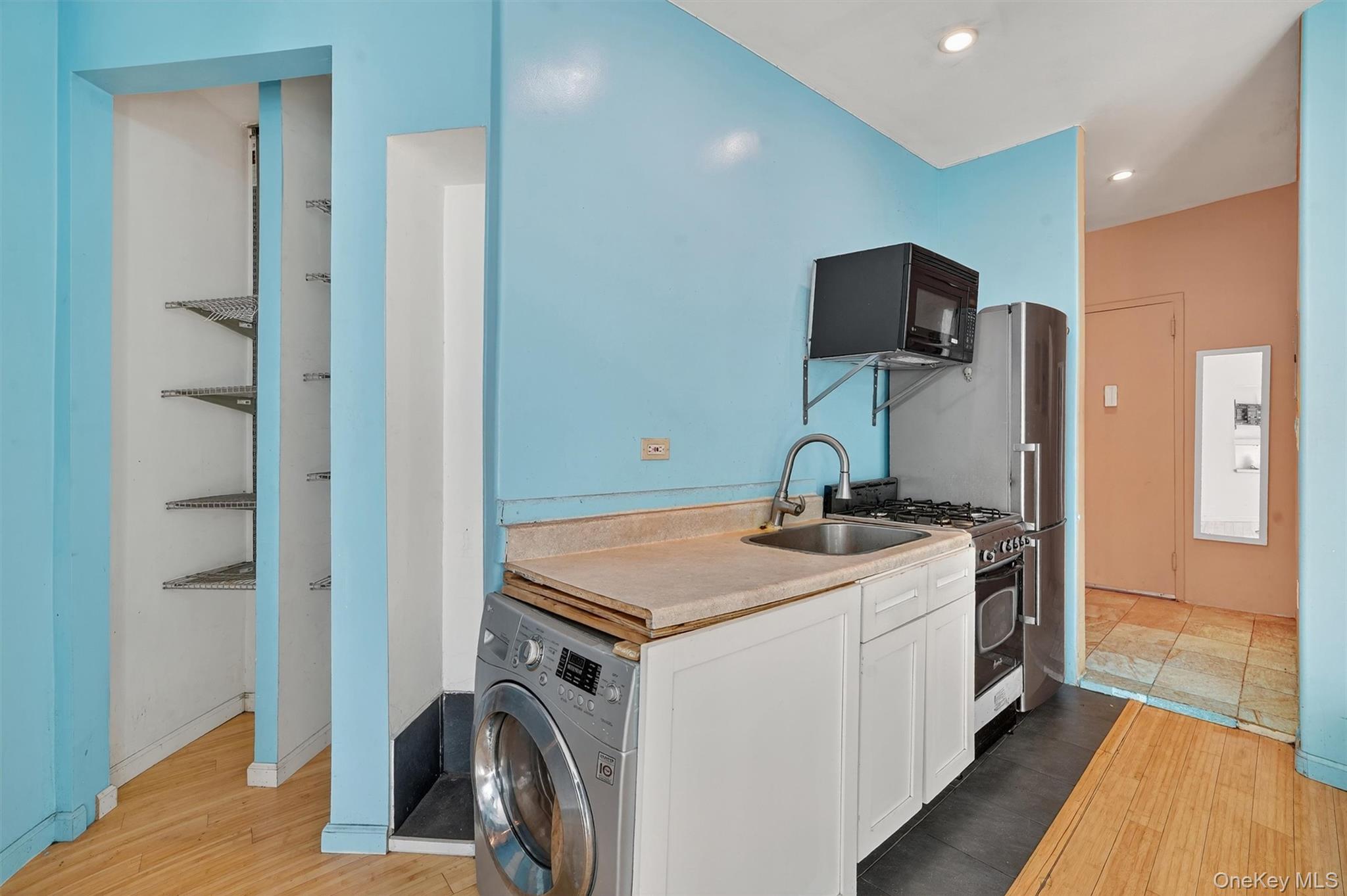 941 Jerome Avenue, Unit 8F Bronx, NY 10452 - Photo 11 of 17 a view of a kitchen with a sink and a refrigerator
