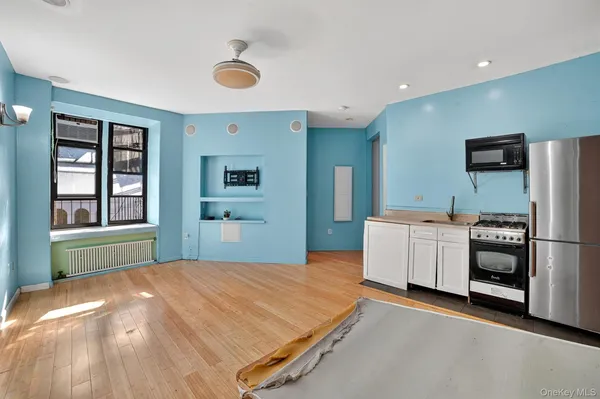 a bedroom with a bed and a large window