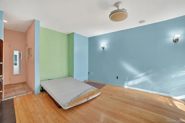 a view of a room with wooden floor