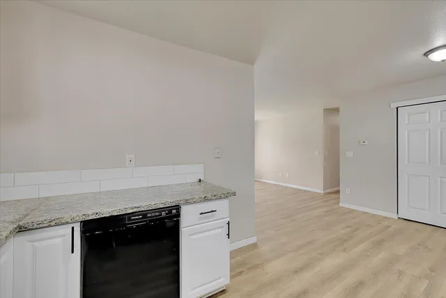 an empty room with wooden floor