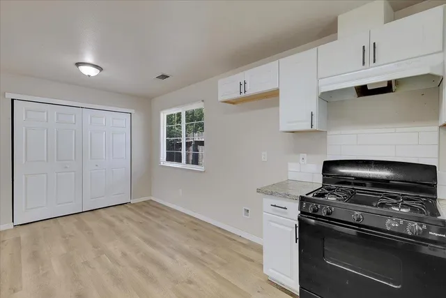 a kitchen with a stove and a microwave