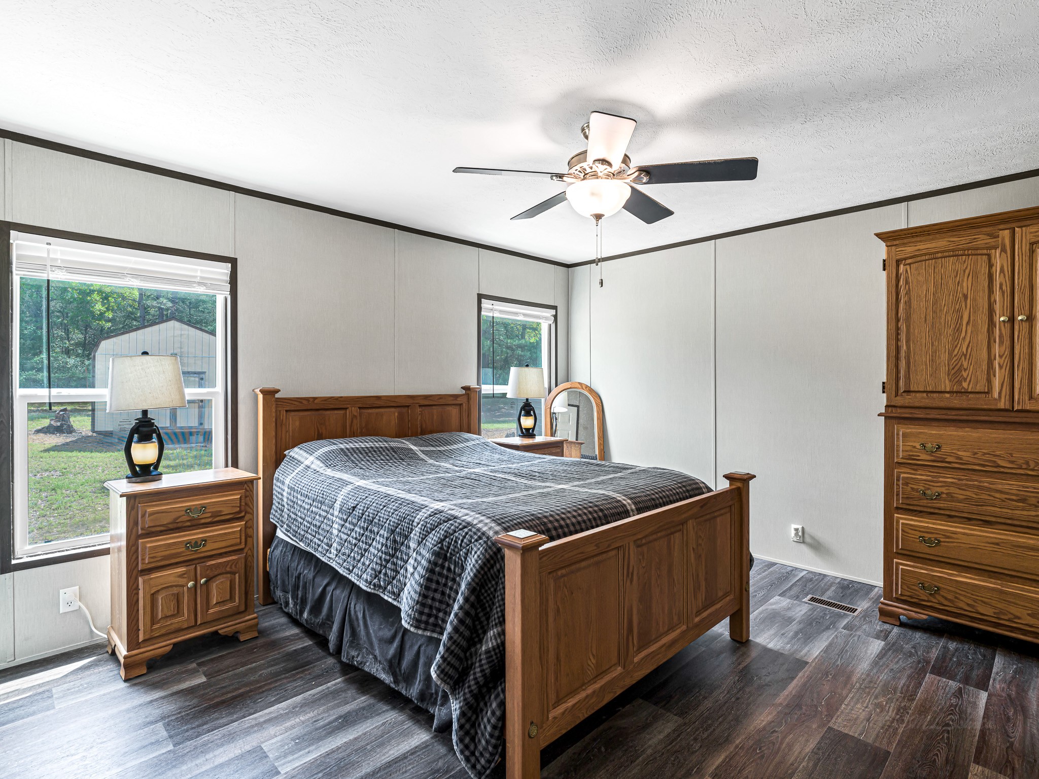 1047 Jimbob Lane New Ulm, TX 78950 - Photo 8 of 18 Spacious primary bedroom features beautiful floors, ceiling fan, large windows and en suite bath!
