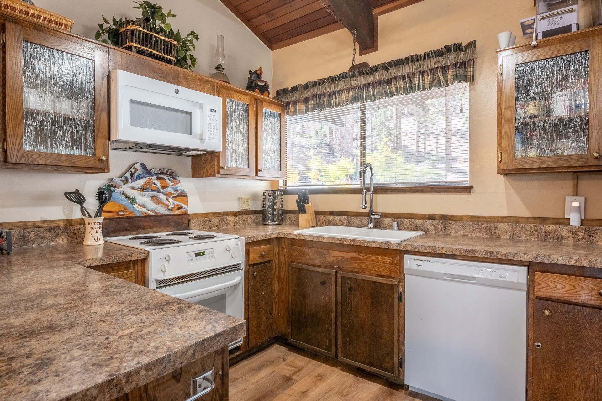 94 John Muir Road, Unit 127 Mammoth Lakes, CA 93546 - Photo 11 of 32 a kitchen with stainless steel appliances granite countertop a stove a sink and a microwave