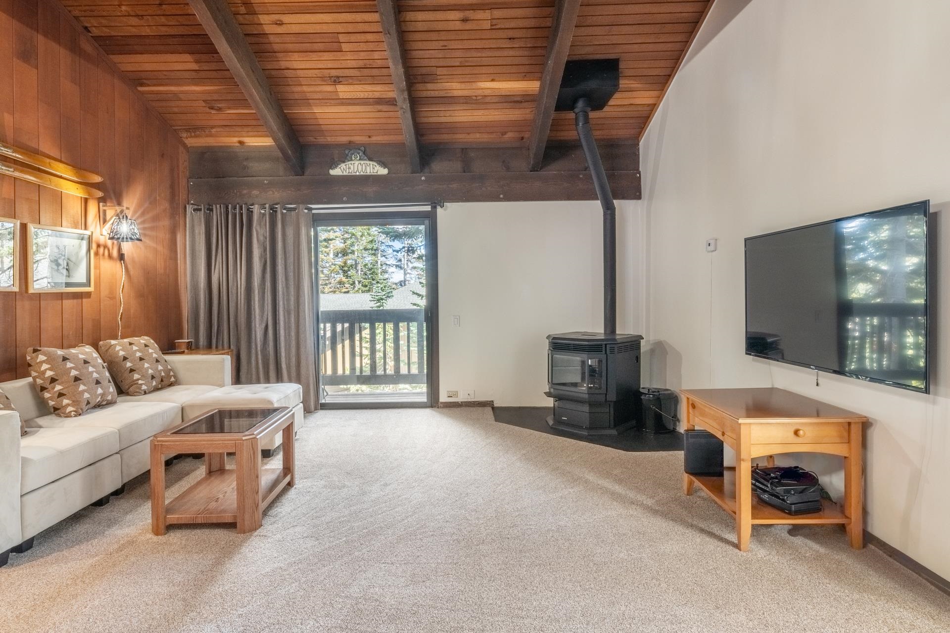 94 John Muir Road, Unit 127 Mammoth Lakes, CA 93546 - Photo 2 of 32 a living room with furniture and a flat screen tv