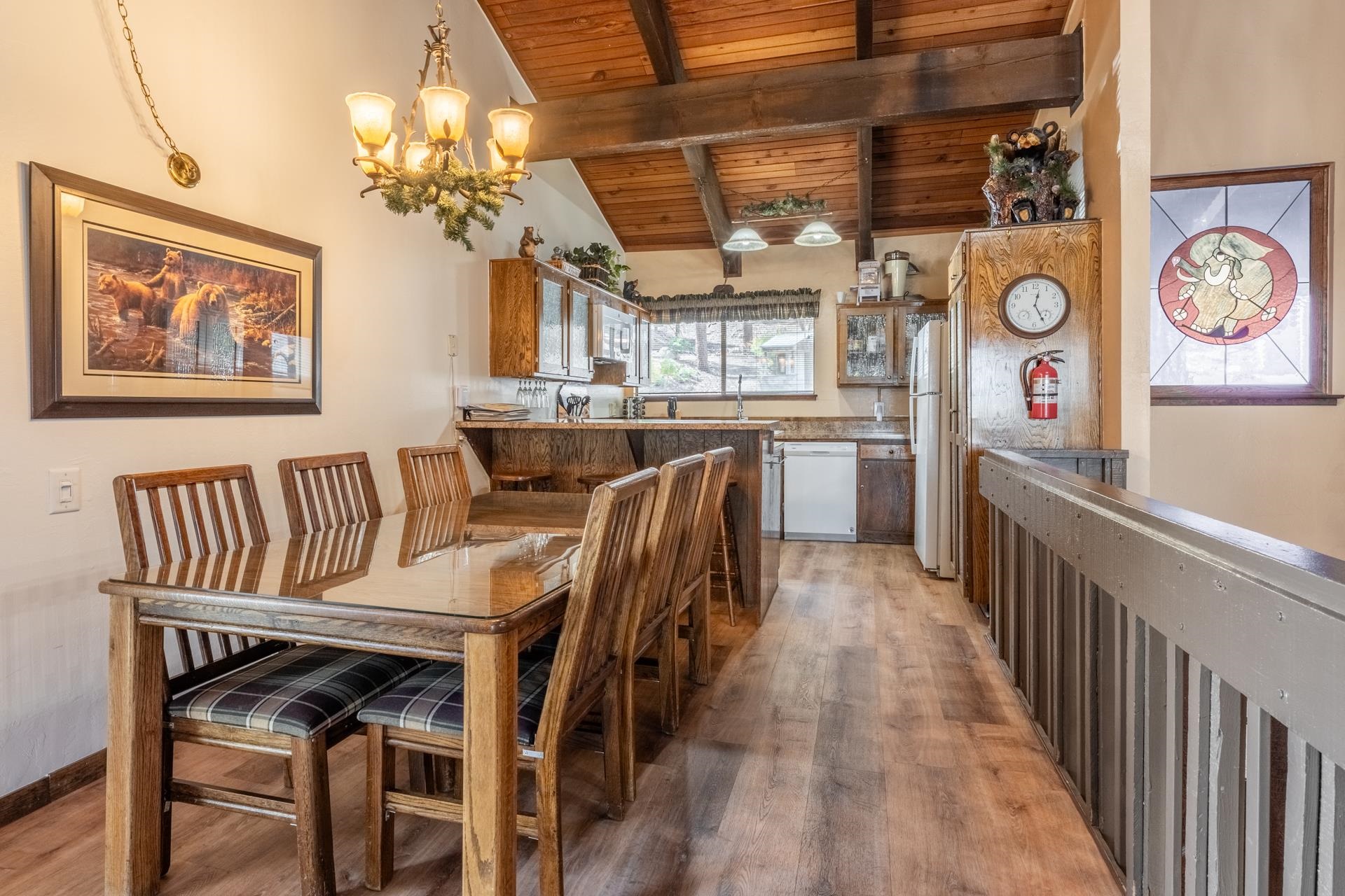 94 John Muir Road, Unit 127 Mammoth Lakes, CA 93546 - Photo 8 of 32 a view of a dining room with furniture a chandelier and wooden floor