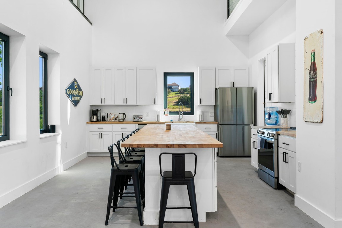 12701 Trails End Road Leander, TX 78641 - Photo 11 of 18 Featuring a large center island with seating, stainless steel appliances and ample cabinet storage.