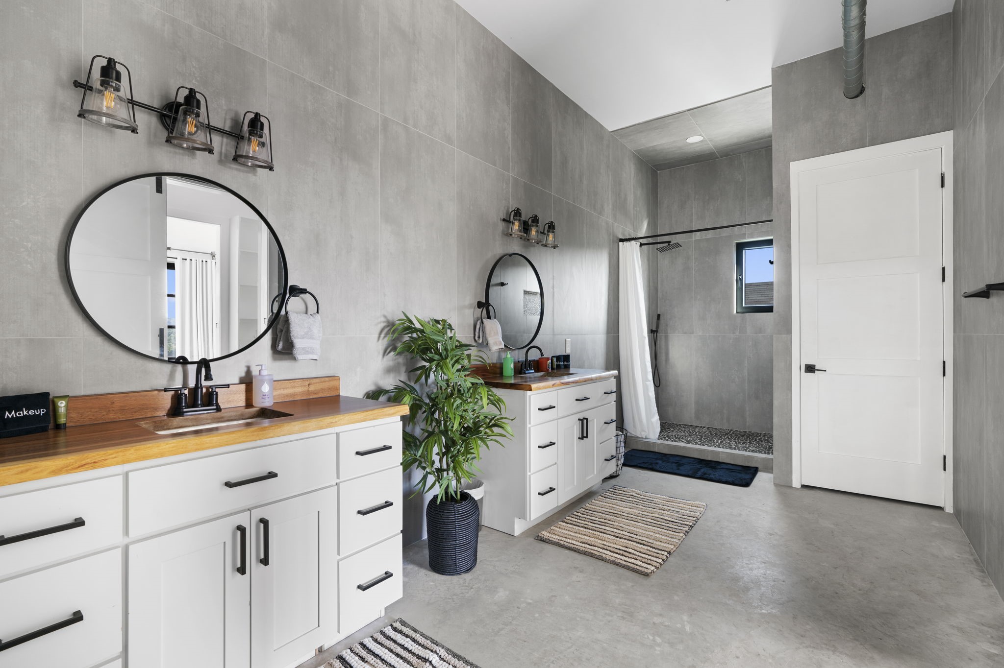 12701 Trails End Road Cedar Park, TX 78613 - Photo 16 of 18 Primary bathroom featuring dual vanities, walk-in shower, concrete floors and modern fixtures.