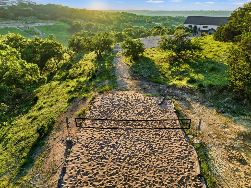 12701 Trails End Road Leander, TX 78641 - Photo 17 of 18 Volleyball Sand Court - Sand volleyball court located on the property with surrounding Hill Country terrain and trail access.