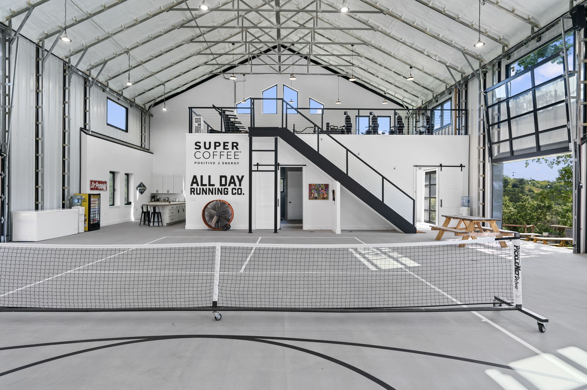 12701 Trails End Road Cedar Park, TX 78613 - Photo 8 of 18 Interior view of the indoor recreation building showing the basketball court, mezzanine level with fitness area, kitchenette and seating area.