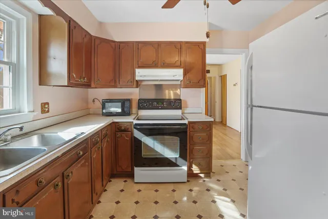 a kitchen with sink cabinets and stainless steel appliances