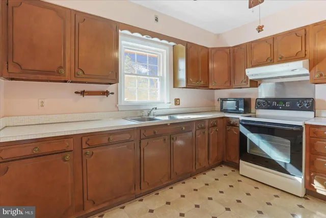 a kitchen with sink cabinets and window