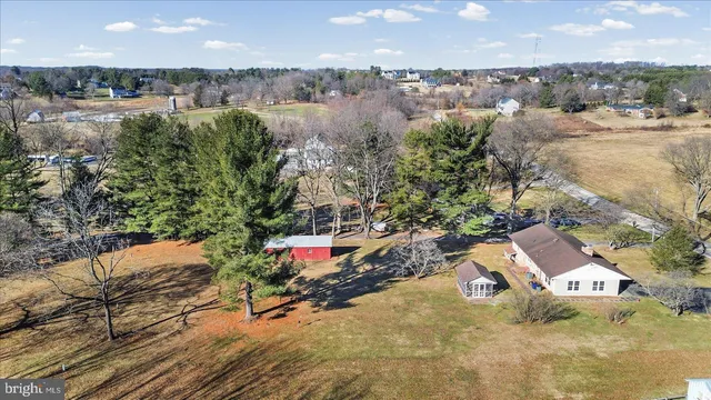 an aerial view of a house with a yard and lake view