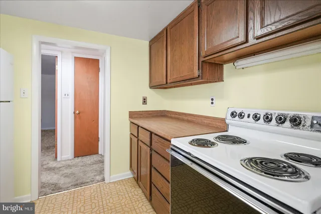 a kitchen with a stove and a refrigerator