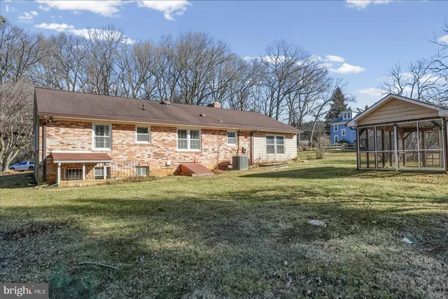 a view of a yard with wooden fence