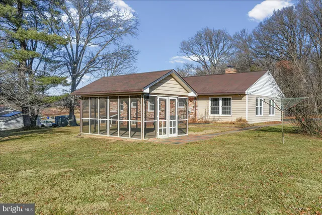 a view of a house with a yard and sitting area