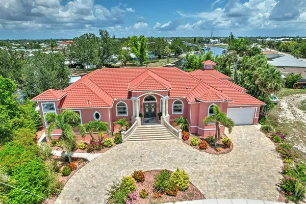 a front view of a house with a yard and green space