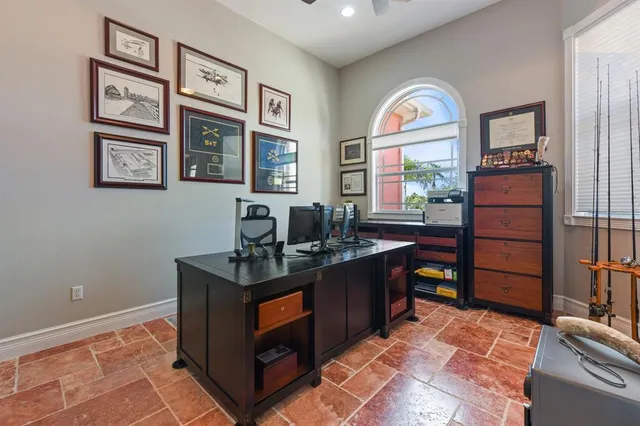 a living room with furniture a flat screen tv and a large window