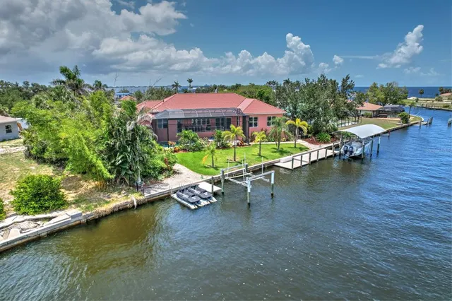 a view of a lake with a table and chairs under an umbrella